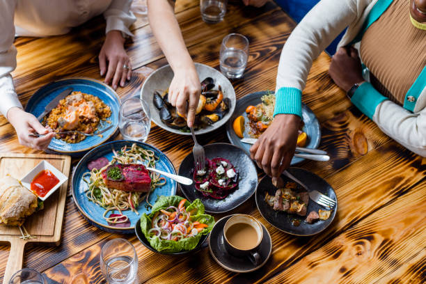 Friends sharing diverse dishes at a communal table